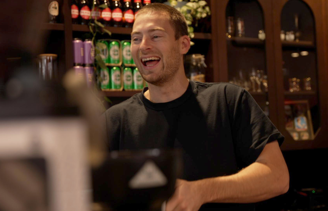 Man smiling working at a restaurant
